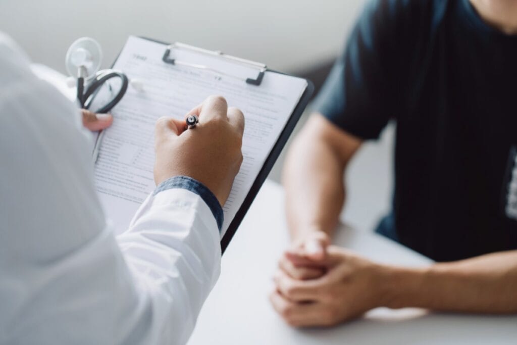 doctor holding test results and consulting patient at desk medic